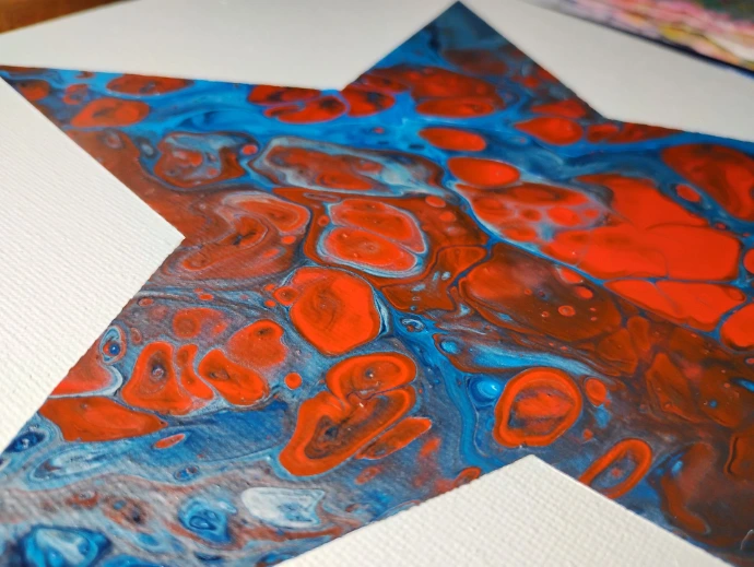 Zoomed in portion of red/white/blue acrylic pour in shape of a star